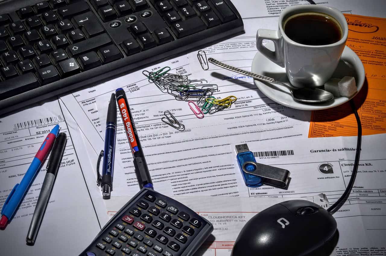 Office workspace with computer keyboard, pens, paper, and coffee at A Place in Javea.