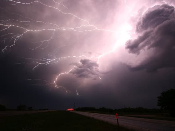 Bright lightning storm over a rural landscape in Javea, Spain, showcasing dramatic thunderstorm activity perfect for outdoor weather and nature enthusiasts.