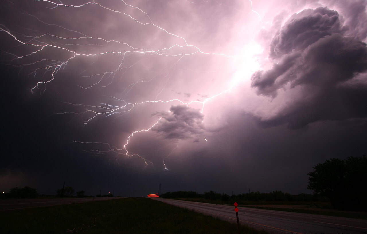 Bright lightning storm over a rural landscape in Javea, Spain, showcasing dramatic thunderstorm activity perfect for outdoor weather and nature enthusiasts.